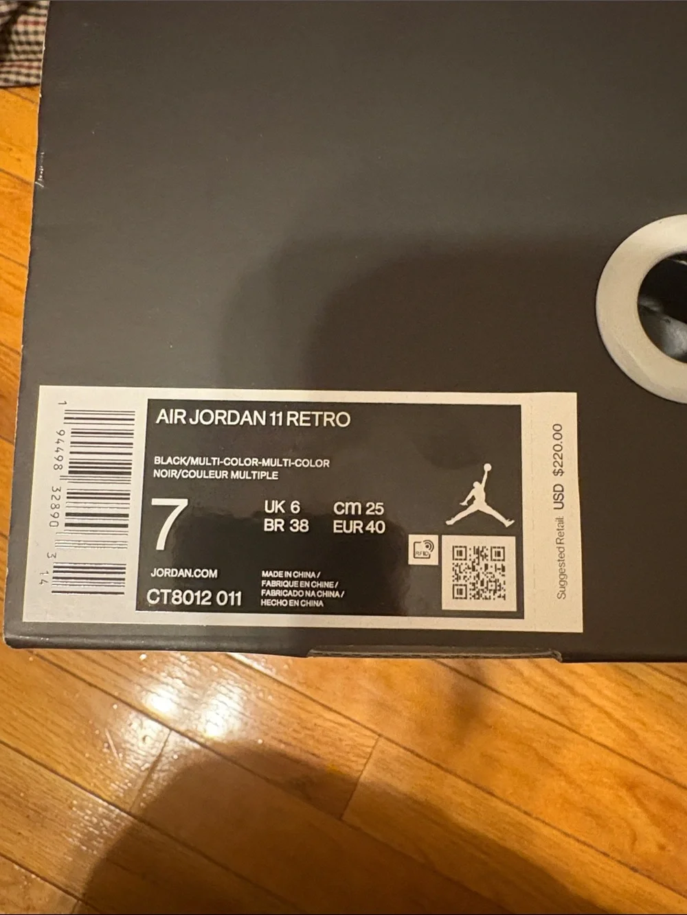 Air Jordan 11 Retro Black Patent and White-Trim High-Top Sneakers